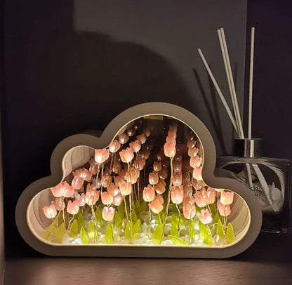 Pink illuminated tulips inside the cloud-shaped mirror