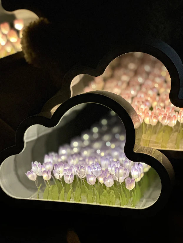 Purple illuminated tulips inside the cloud-shaped mirror