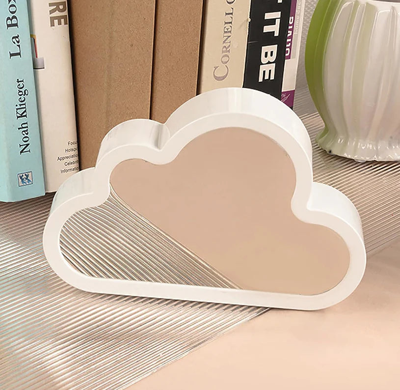 Amora cloud-shaped mirror reflecting a room in daylight